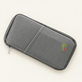 Gray zip travel document organizer with an exterior pocket and embroidered pattern