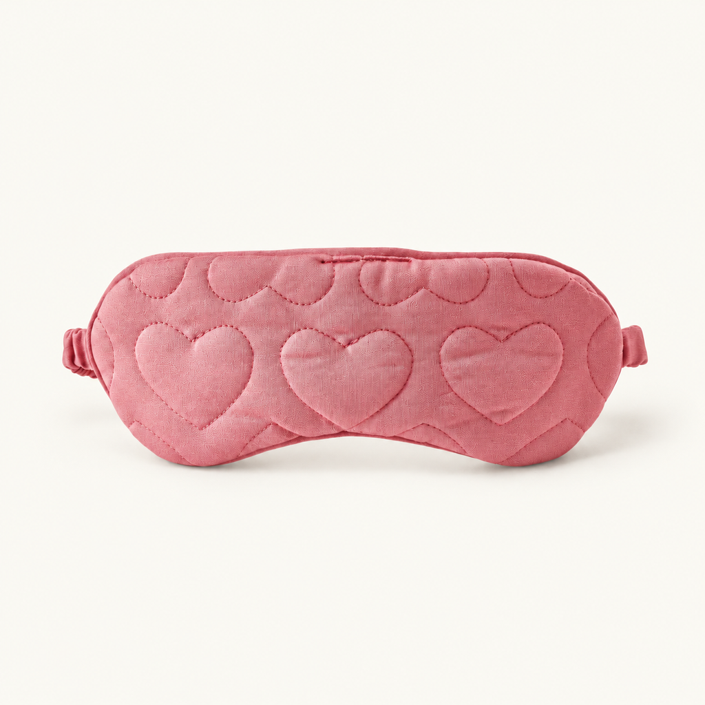 Rose-pink sleep mask with heart quilting and a side strap