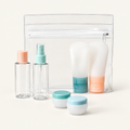 Seven-piece travel toiletry kit: clear zip pouch, two bottles, two squeeze tubes and two jars with pastel caps
